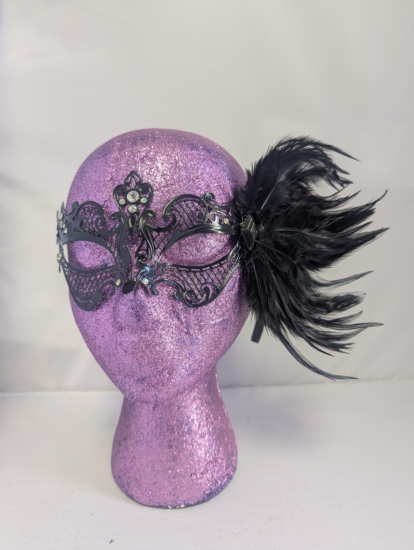Black metal mask with gems and black feathers